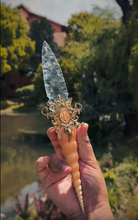 Load image into Gallery viewer, Macro close-up of the dagger's hilt, featuring a genuine ammonite fossil, shimmering abalone shell, and an ornate bronze cap