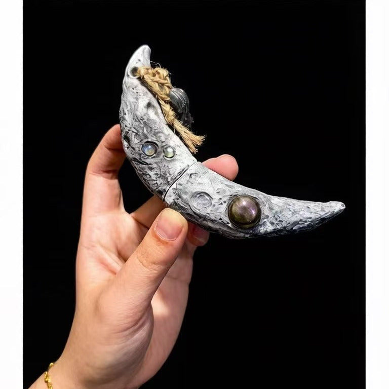 Premium handmade crescent moon Witchblade pendant showcased on a black background. Features realistic lunar crater texture, embedded gemstones (Labradorite/Moonstone), and a mystical crystal charm. Ideal for spiritual rituals and esoteric practices.