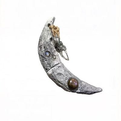 Handcrafted Crescent Moon Witchblade pendant featuring realistic lunar crater texture, inlaid with Labradorite and Moonstone, attached with a natural crystal charm. Perfect for Wiccan rituals and spiritual practices.